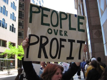 Protest sign of People over Profit CC license