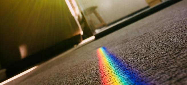 Sunlight streaming through the window, throwing a rainbow on the carpet.